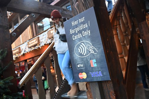 Schild vor einer Treppe von einem Restaurant mit dem Hinweis "Hier nur bargeldlos, nur Kartenzahlung, kein Bargeld"